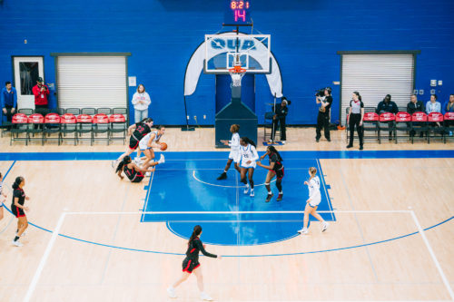 A TMU player gains possession and looks to make her next move amidst opponents