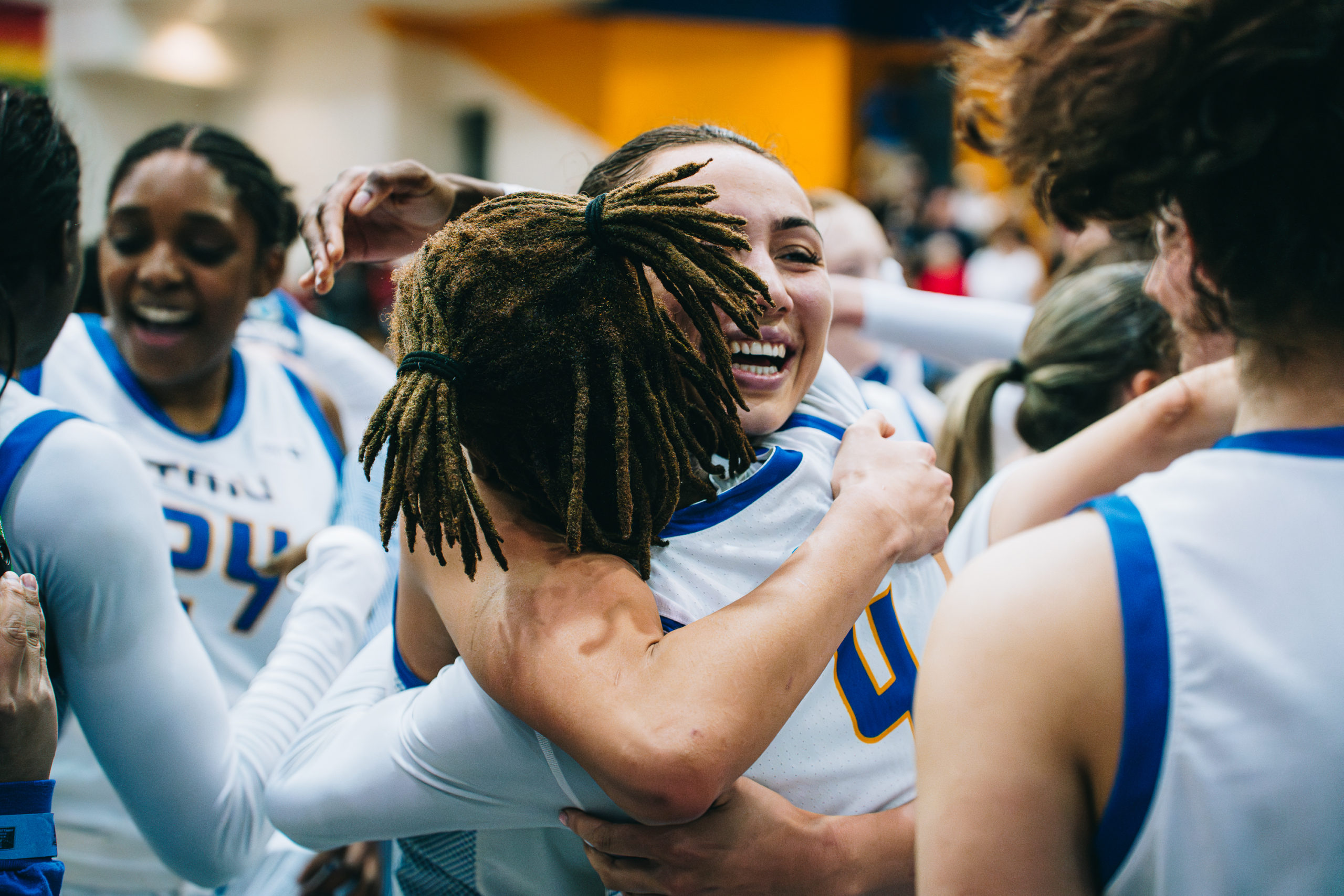 Hailey Franco DeRyck and Myriam Kone share a hug, celebrating their OUA Championship win