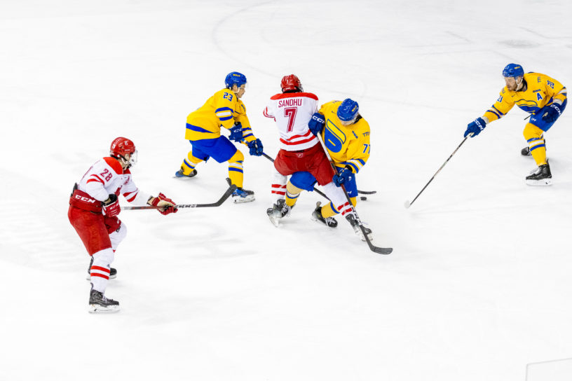 TMU and York battle for possession on the ice