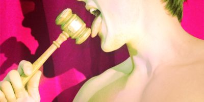 A male student licks a gavel.