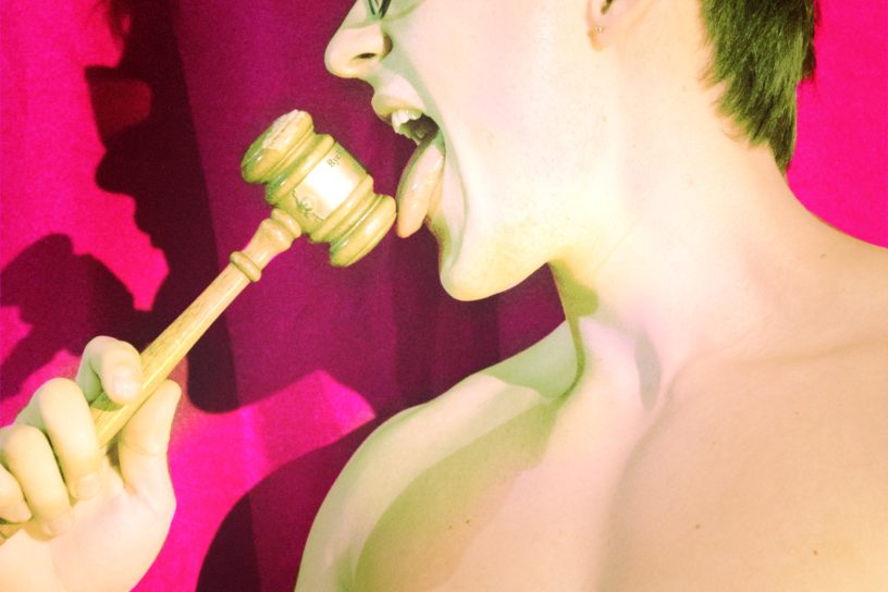 A male student licks a gavel.
