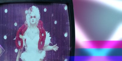 A vintage looking television features a brightened image of drag queen Van Goth