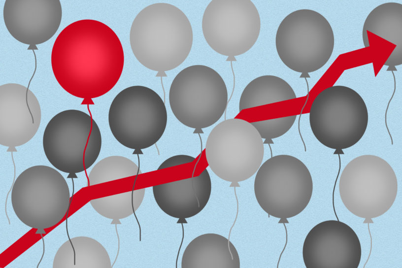 Graphic of a red arrow in the centre around grey balloons and one red balloon on the top left.