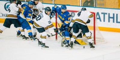 Windsor players crowd TMU's net, trying to get a goal amidst TMU defenders