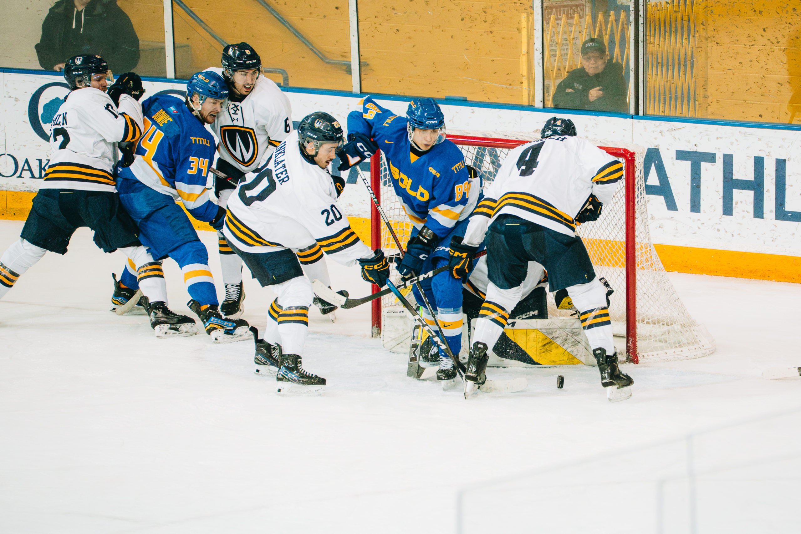 Windsor players crowd TMU's net, trying to get a goal amidst TMU defenders