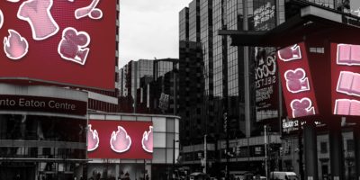 A photo illustration of a city square filled with billboards of various icons relating to sports and pop culture