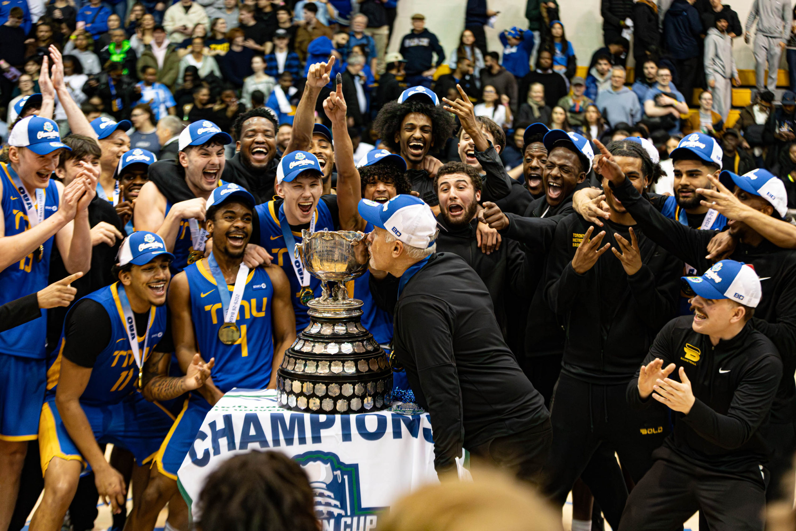 TMU Bold men's basketball team celebrate their 2026 Wilson Cup championship at the Mattamy Athletic Centre