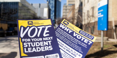 TMSU general elections pamphlets held up on Toronto Metropolitan University's campus.