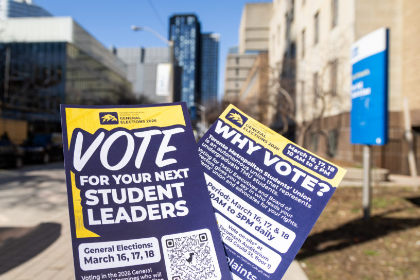 TMSU general elections pamphlets held up on Toronto Metropolitan University's campus.