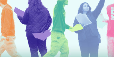 Students holding up resumes and walking around this resumes in their hand. There are coloured filters over the students.