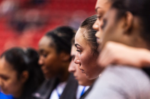 Hailey Franco DeRyck in a huddle on the TMU bench during a stoppage of play