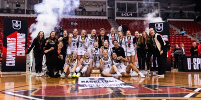 The University of Saskatchewan Huskies pose for a photo with their championship banner and trophy