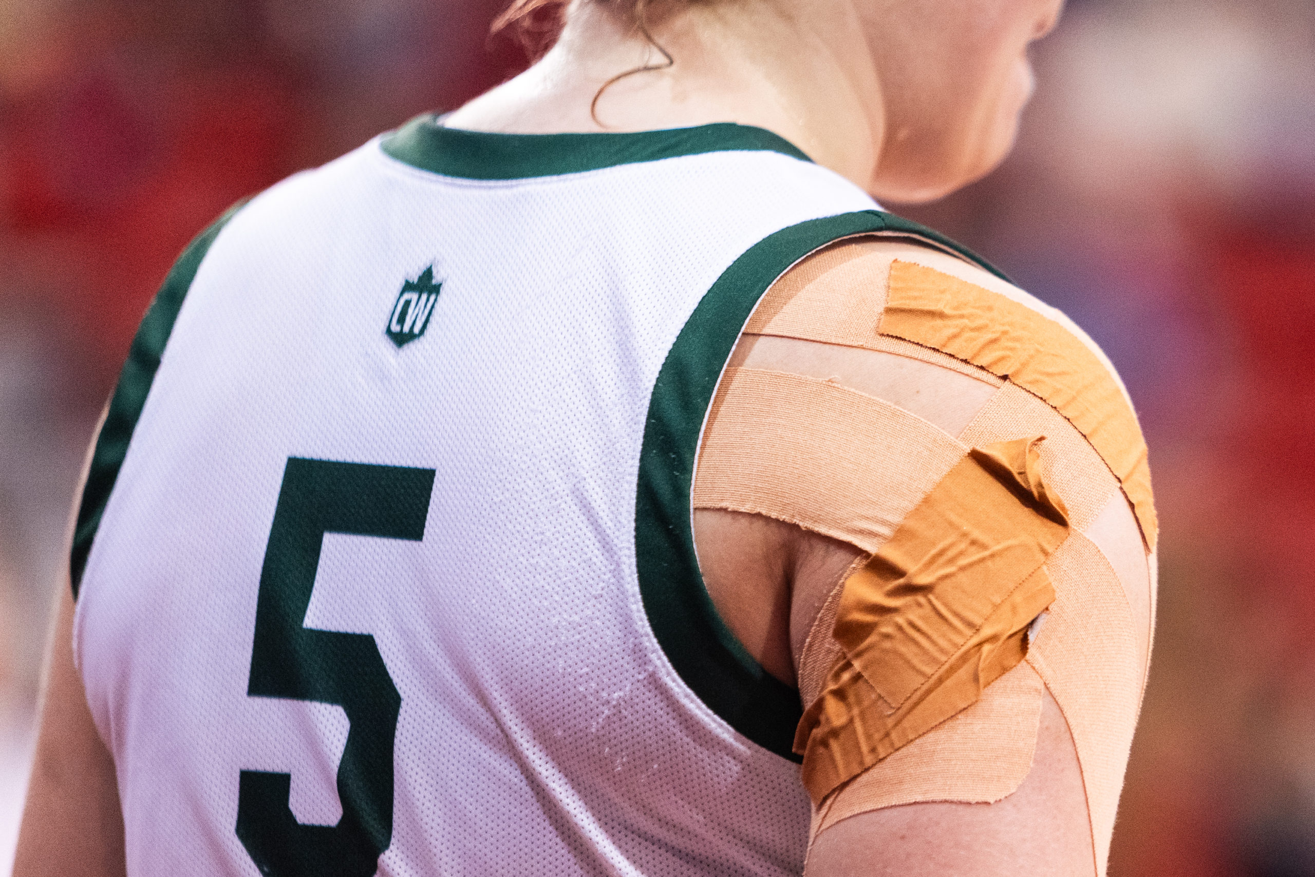 A Huskies player has her right shoulder taped up