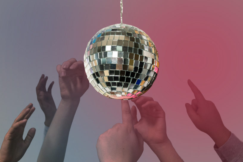 Image of a disco ball with photos of hands on the bottom. There are pink and blue hues in the background