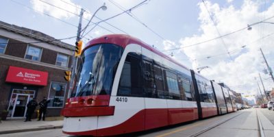 A streetcar moves along down the street
