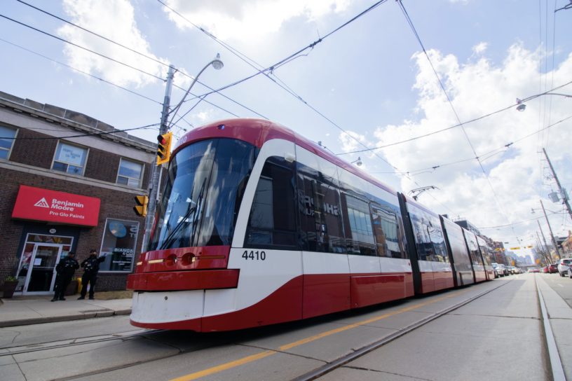 A streetcar moves along down the street