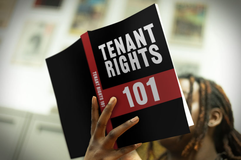 Photo of someone holding a book that reads "Tenant Rights 101".