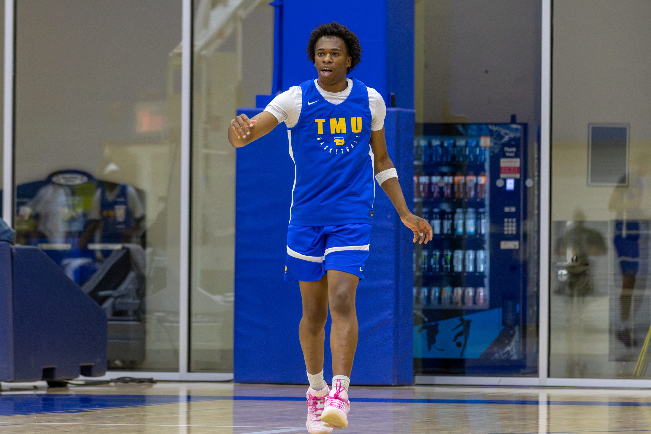 TMU player Tobe Ezeokafor walks in the back court while coaching his teammates.
