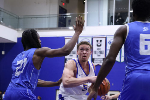 Two George Brown players defend against a TMU player