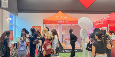 Students huddle around a booth at a Shein pop-up event.