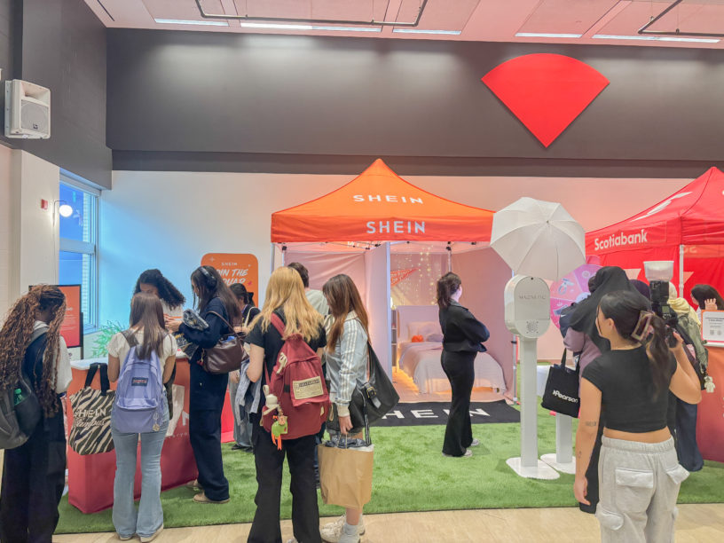 Students huddle around a booth at a Shein pop-up event.