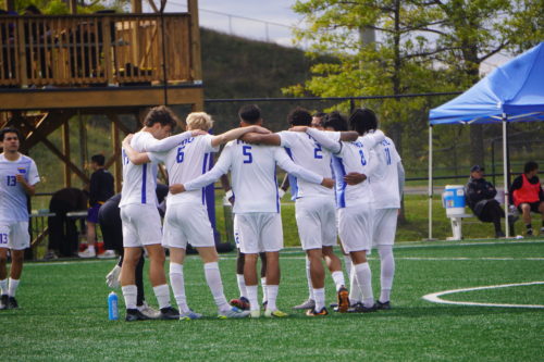 Bold players hug on the field.