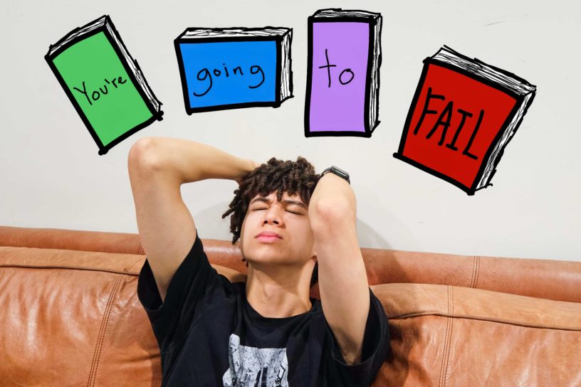 Image of someone appearing to be distraught, with four textbooks reading out "You're" "going" "to" "FAIL".