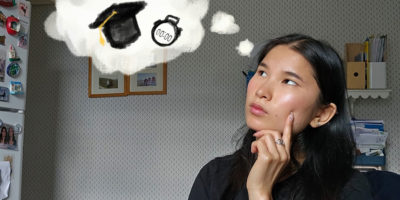 A girl sits in her room with a thought bubble above her head showing a graduation cap and a clock.