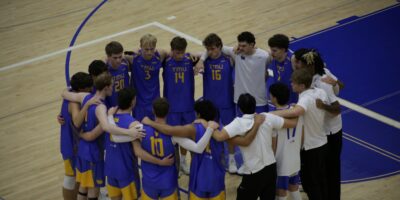 Bold volleyball athletes gather in team circle