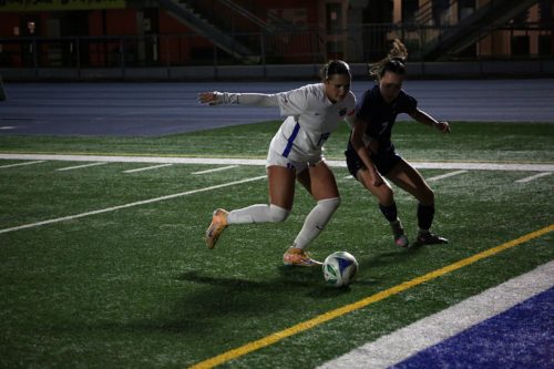 TMU and U of T player battle in a ground duel