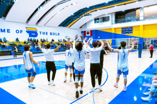 TMU men's volleyball team celebrates