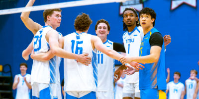 The Bold men's volleyball embrace at the net