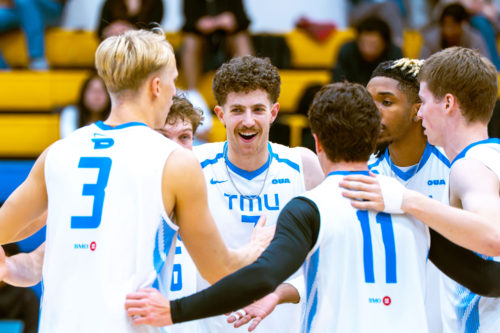 The TMU men's volleyball team embrace