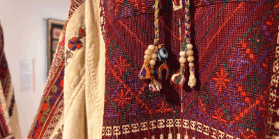 A photo from the Retracing Tatreez exhibit. It is a close-up detail shot of a garment.