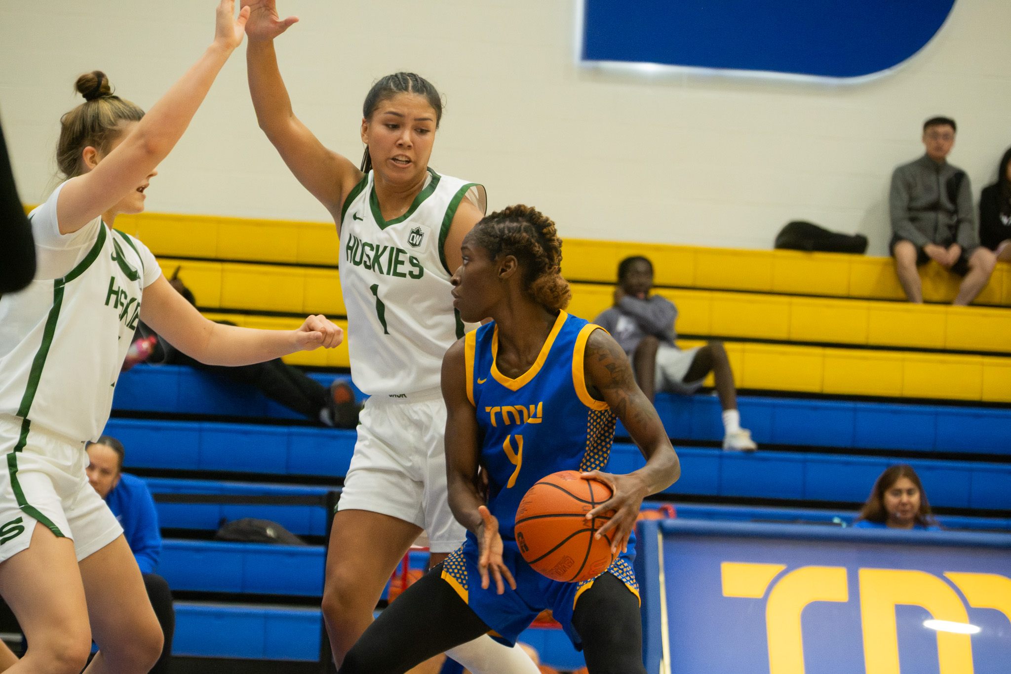 TMU player guarded by two Saskatchewan players