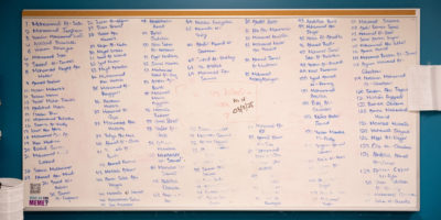 A picture of the whiteboard in the journalism student lounge, where the names of journalists killed in Gaza are written out.