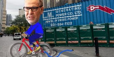 A photo illustration of President Mohamed Lachemi on a bicycle, supposedly powering the generators outside of the Victoria Building, however, the cord is not plugged in.