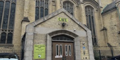Picture of Trinity Square Cafe entrance, with the sign saying "Cafe" and its open hours
