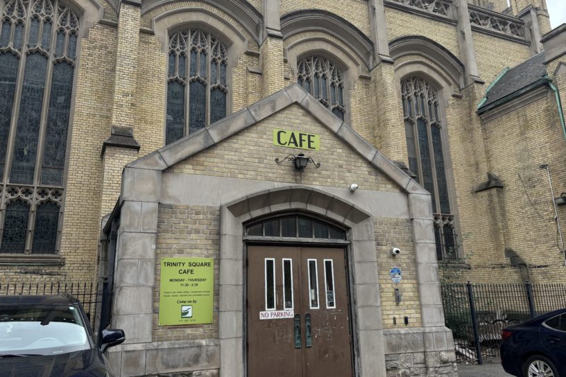 Picture of Trinity Square Cafe entrance, with the sign saying "Cafe" and its open hours