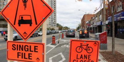 Photo of signs that indicate a bike lane closure.