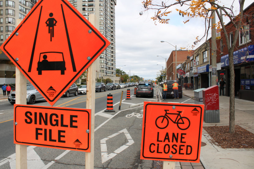 Photo of signs that indicate a bike lane closure.